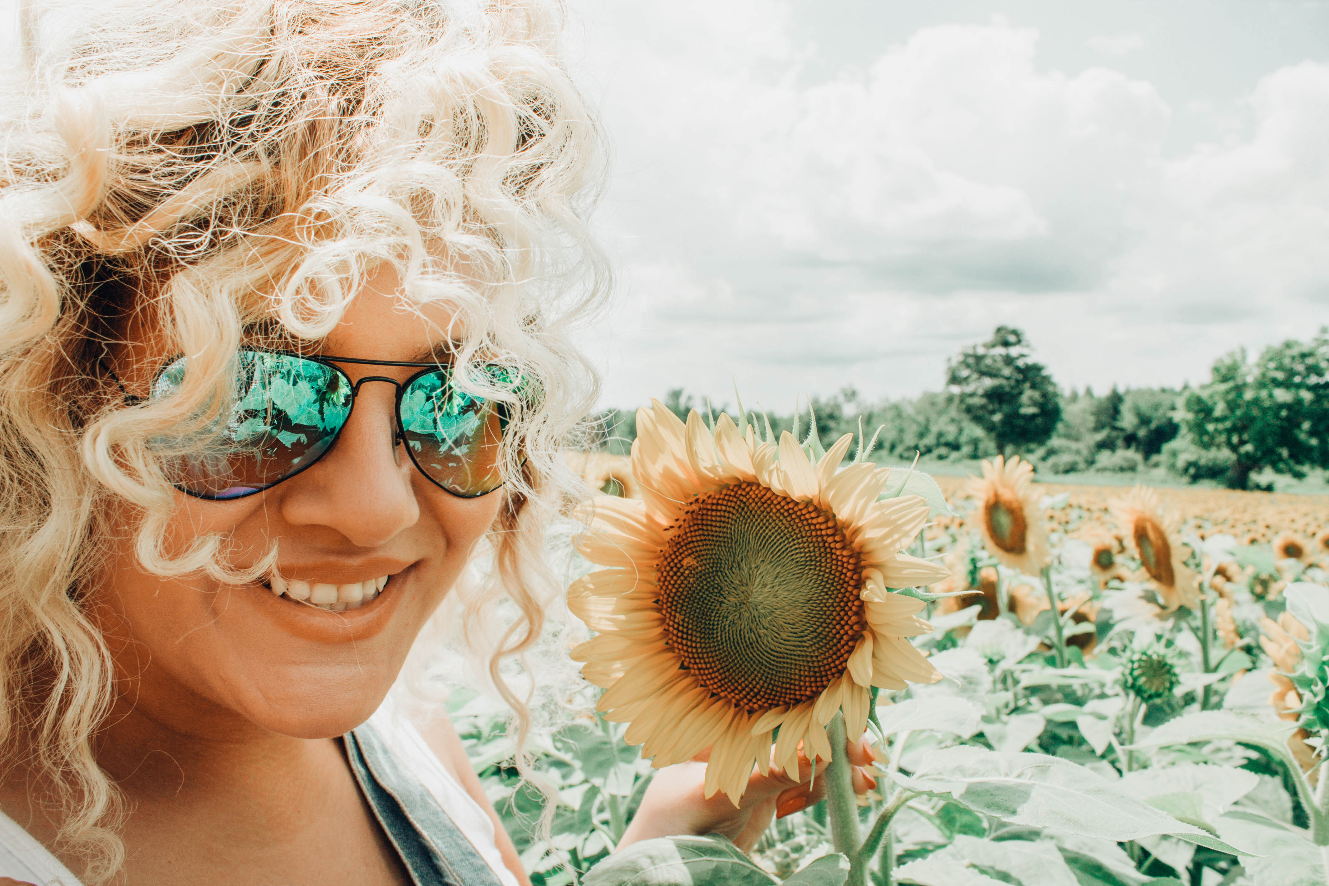 Canva - Smiling Woman Holding Sunflower